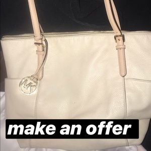 white leather Micheal Kors purse.